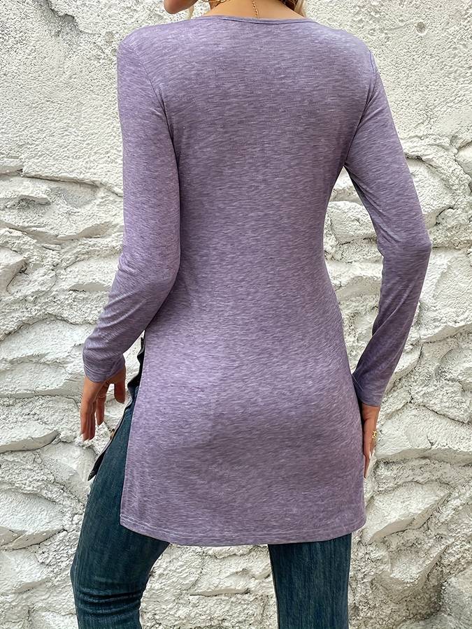 T-shirt med rund halsudskæring og lange ærmer, mellemlang længde og slids forneden, ensfarvet