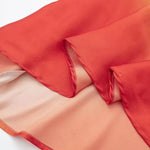 Cassandra - Gradient halter neck kjole med rygløst design